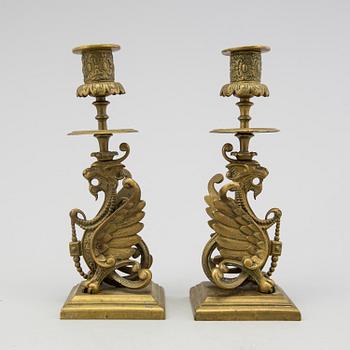 A pair of brass candle sticks late 19th century.