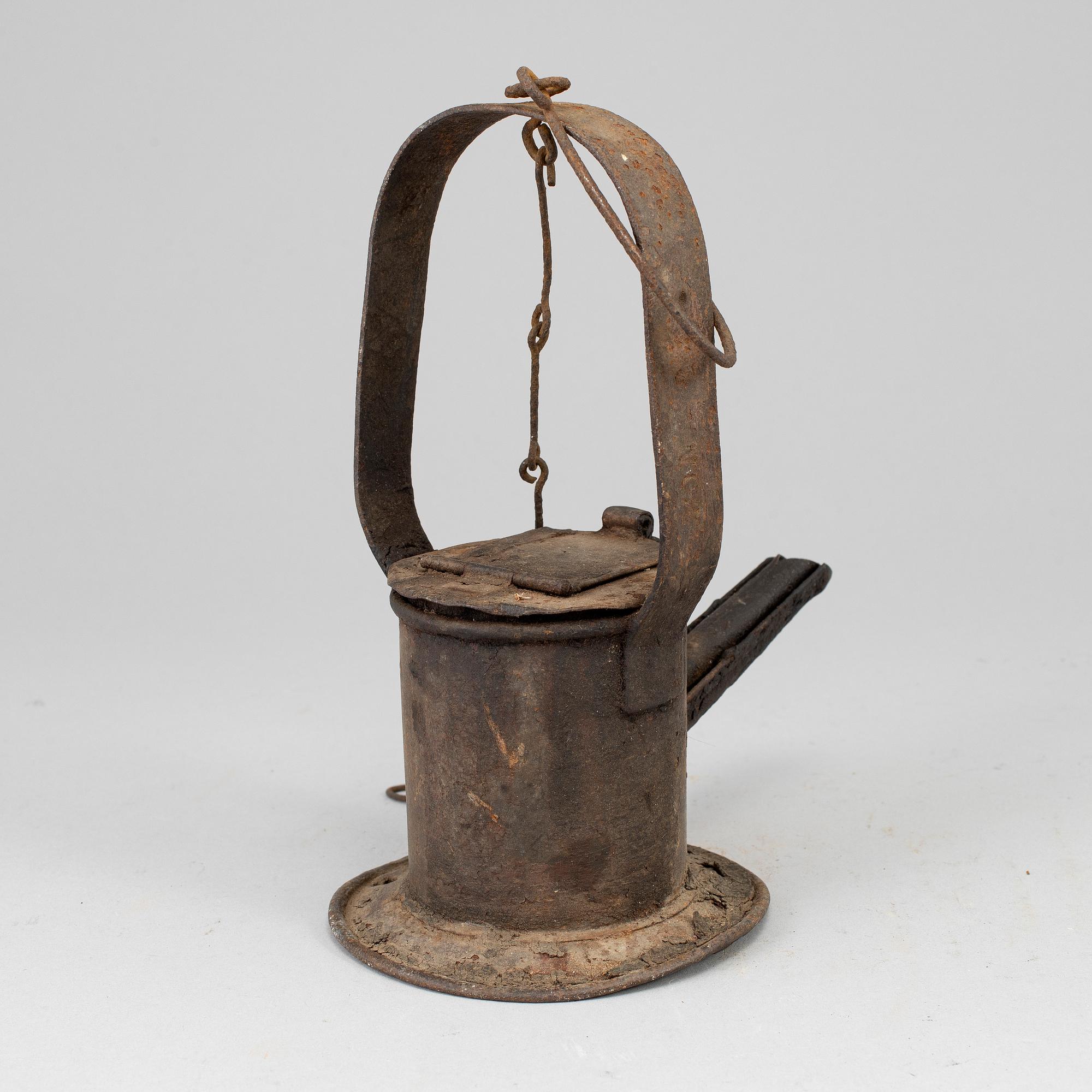 A 19th century tinplate oil lamp.