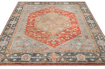 An oriental carpet with Mamluk design, c. 359 x 281 cm.
