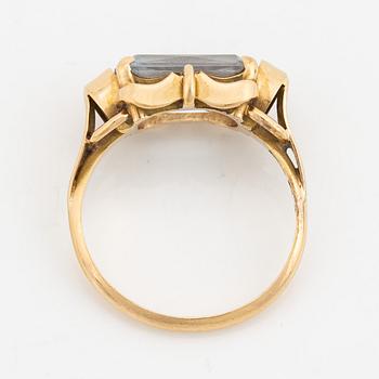 An 18K gold ring set with a synthetic spinel.