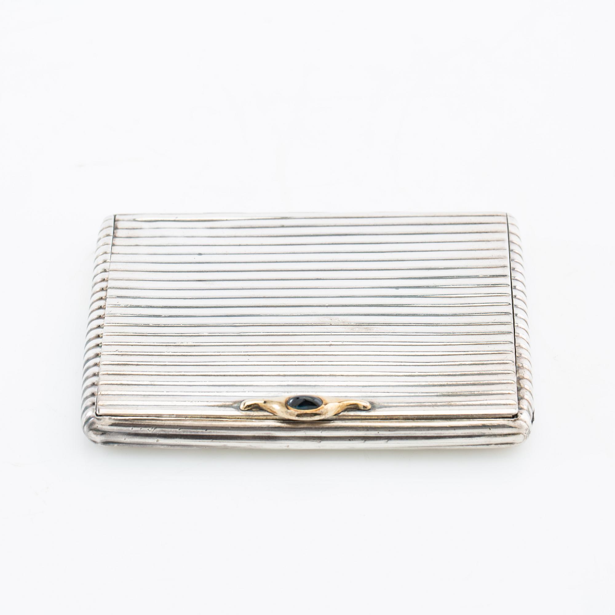 Cigarette case of silver with a cabochon-cut blue stone, first half of the 20th century.