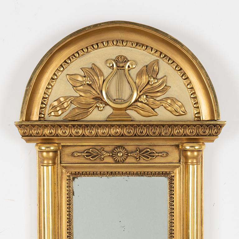 An Empire mirror, first half of the 19th century.