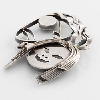 Atelier Borgila, brooch, silver, in the shape of masks.