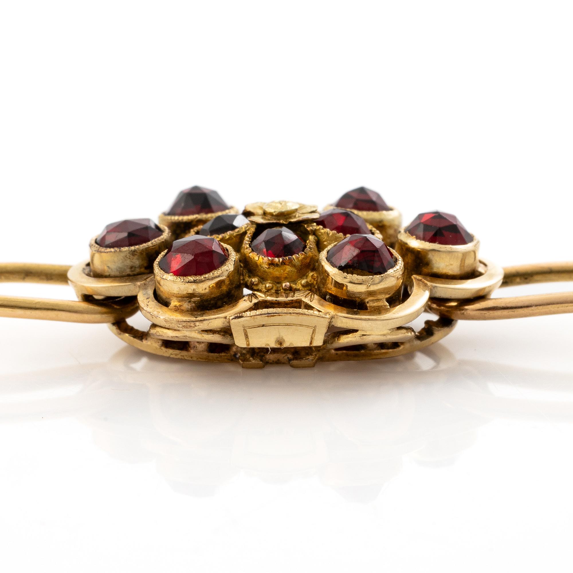 Gustaf Dahlgren & Co, Malmö, 1961. Bracelet in 18K gold with a centrepiece in 14K gold and garnets.