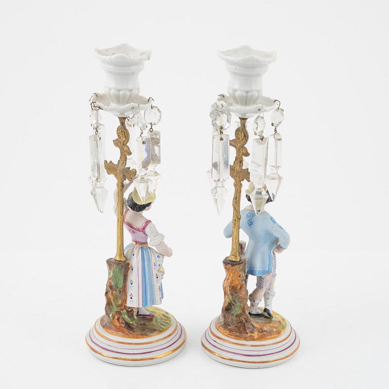 A pair of porcelain Rococo style candlesticks, late 19th Century.