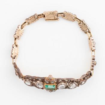 A 14K gold and silver bracelet set with an emerald and rose-cut diamonds.