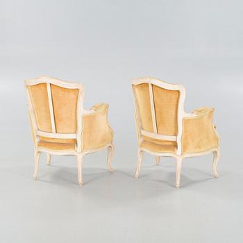 A pair of rococo style lounge chairs, first half of the 20th century.