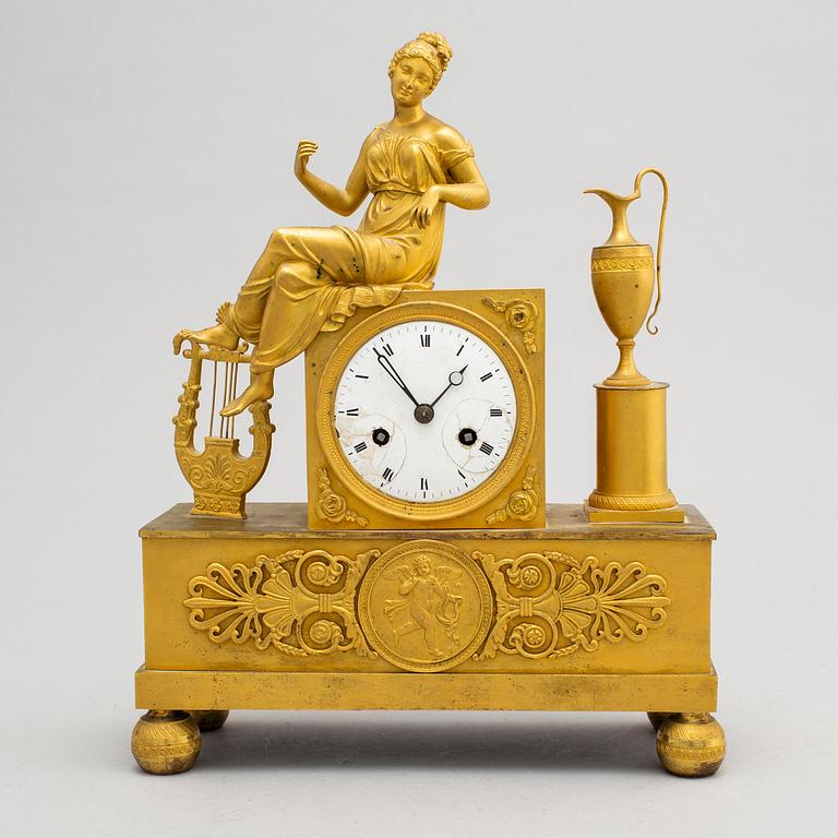 A first half of the 19th century Empire bronze mantle clock.
