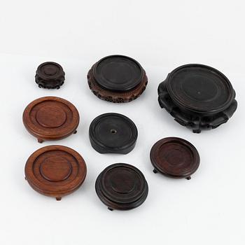 A set of eight Chinese wooden stands, late Qing dynasty/early 20th Century.
