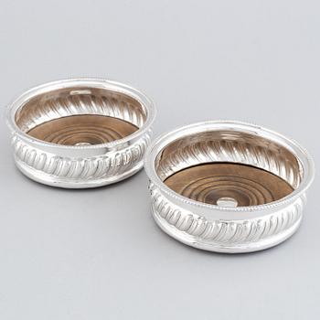 A pair of silver plated coasters.