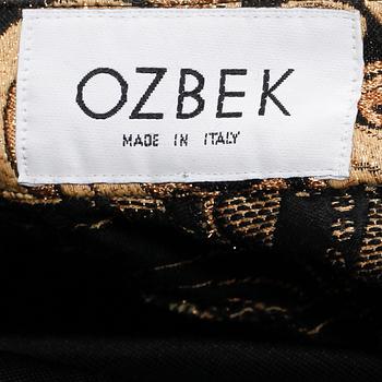 OZBEK, a polo-neck sweater and trousers.