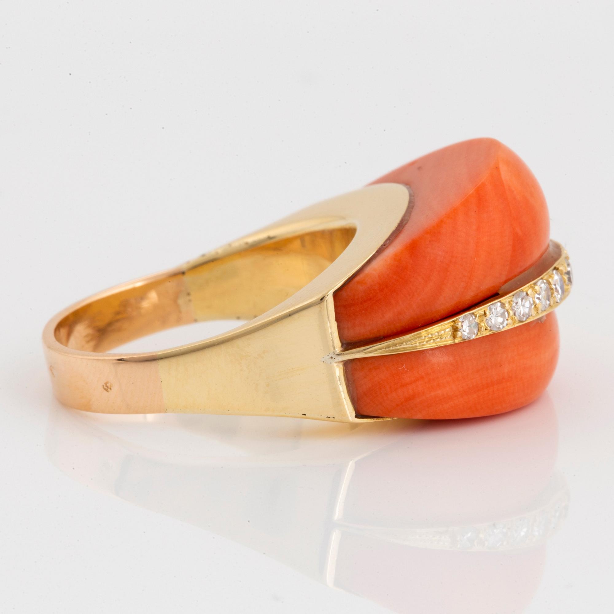 An 18K gold and coral ring set with eight-cut diamonds.
