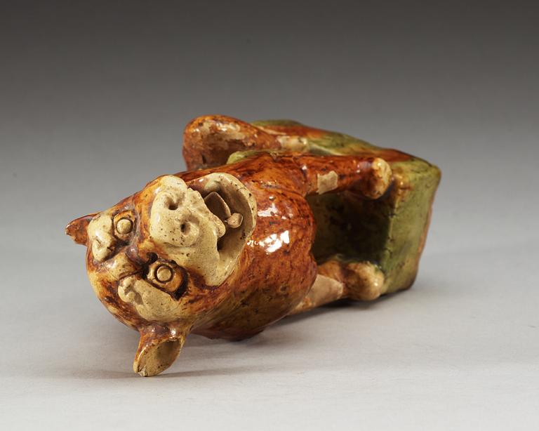 A potted figure of a 'Buddhist Lion', Tang dynasty (618-907).