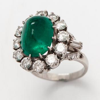 A platinum ring with a ca. 8.50 ct emerald and diamonds ca. 2.84 ct in total. With certificate.