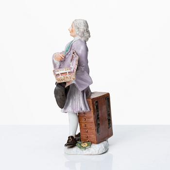 A Meissen porcelain figure of a trinket salesman from the series of Parisian street-traders, circa 1745.