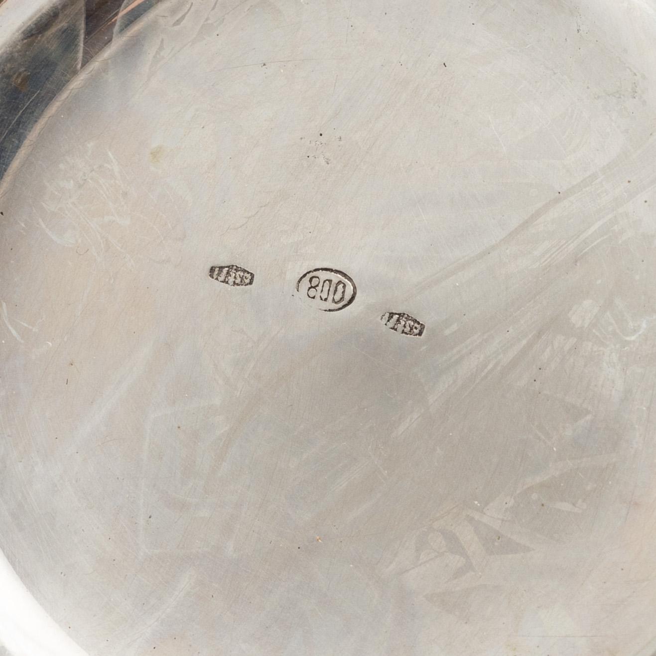 Three Silver Shakers and a Beaker.