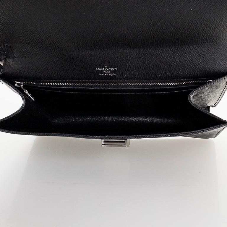 Louis Vuitton, a 'Selenga' clutch bag.