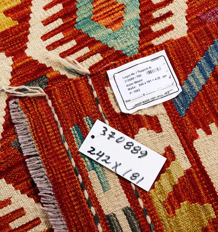 A Kilim rug, c. 242 x 181 cm.