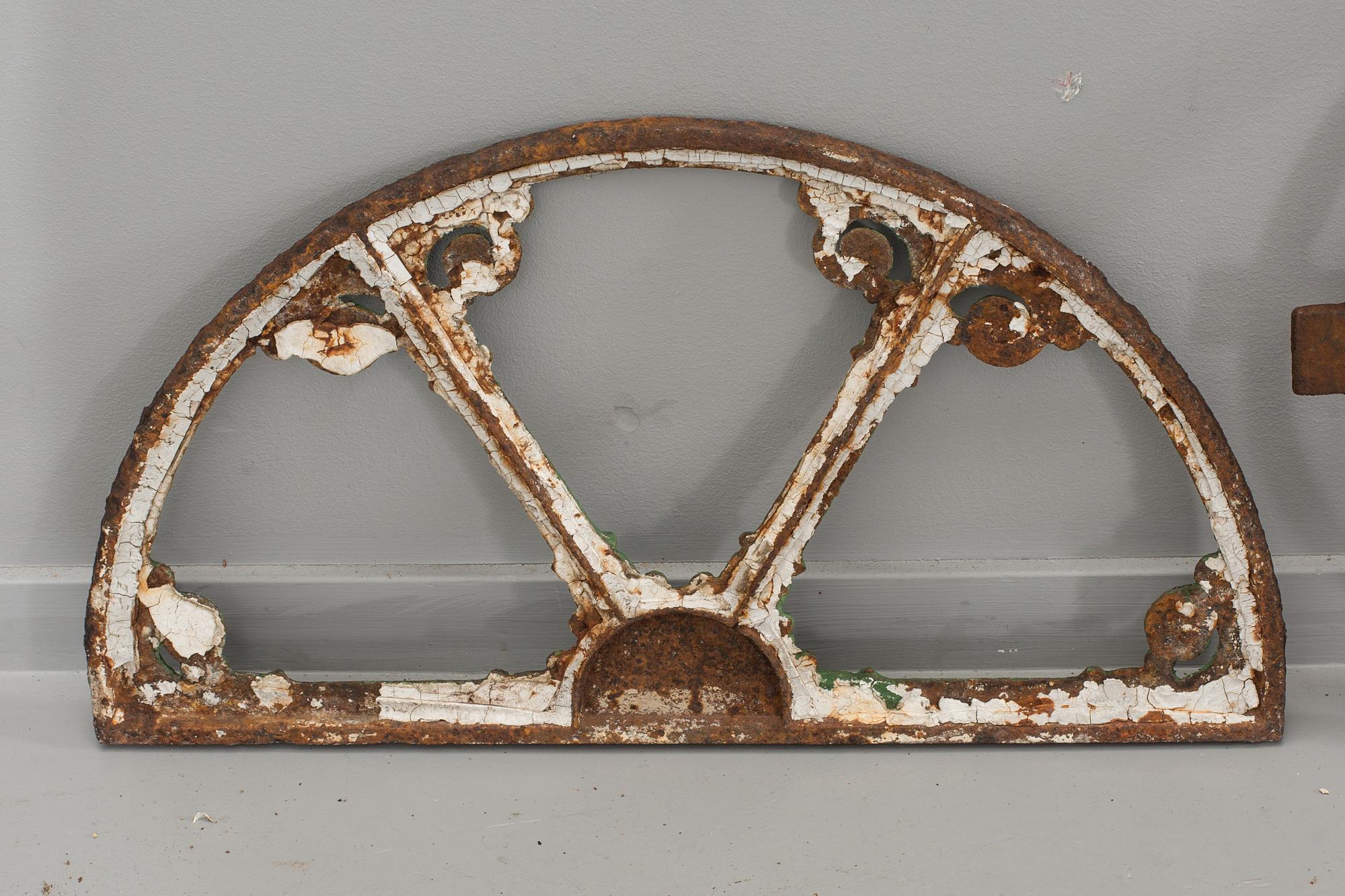 A SET OF THREE CAST IRON WINDOWS.