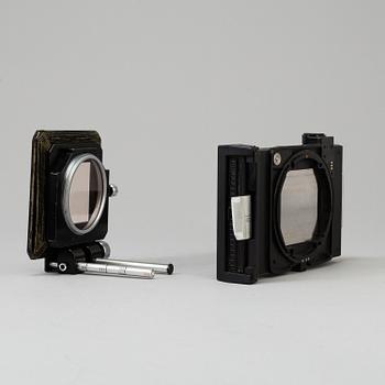 A black Mamiya RZ67 Pro Medium Format Camera Body with sekor z f = 110 mm 1:2.8 and sekor c f = 50 mm 1:4.5 lens.