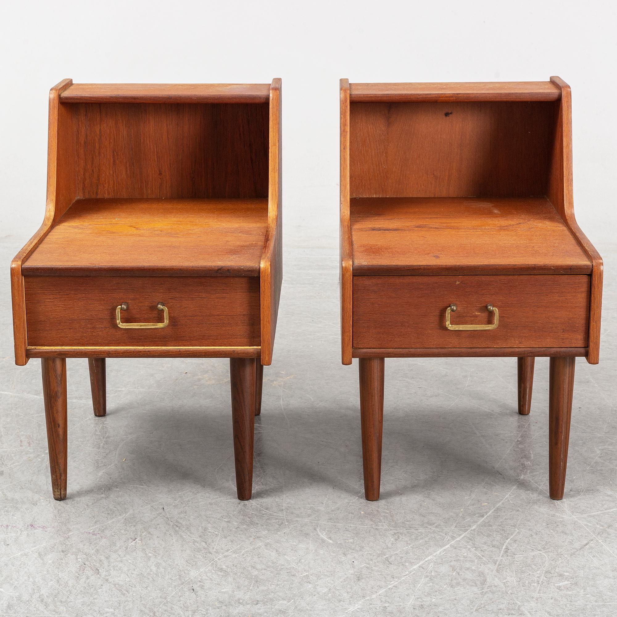 A pair of teak veneered bedside tables.