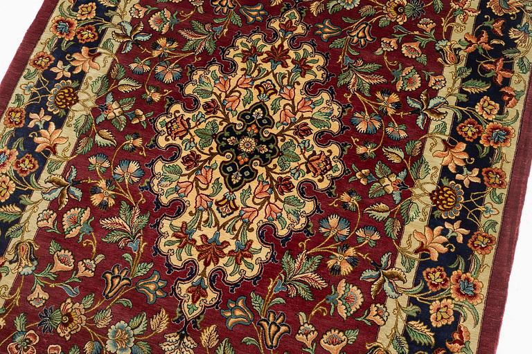 A silk Qum rug, Central Iran, signed, c. 170 x 101 cm.
