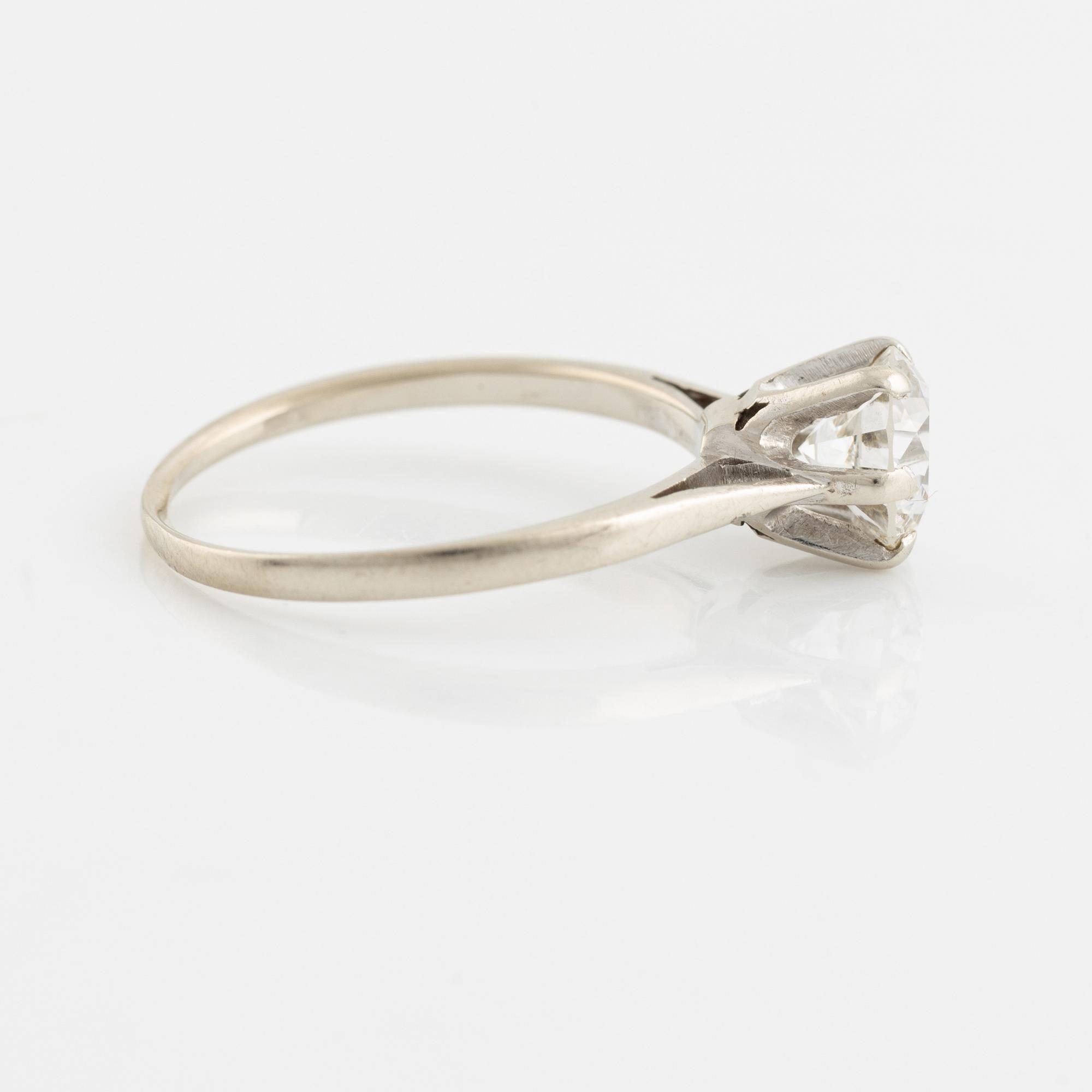 A 14K gold ring set with a round brilliant-cut diamond.