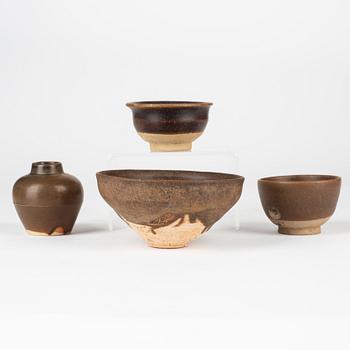 A group of three brown glazed bowls and a jar, South East Asia, 14th/17th Century.