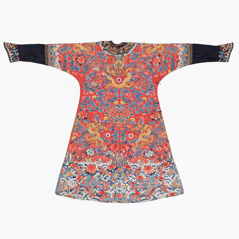 An embroidered red ground five clawed dragon 'female' formal robe, Qing dynasty, 19th century.