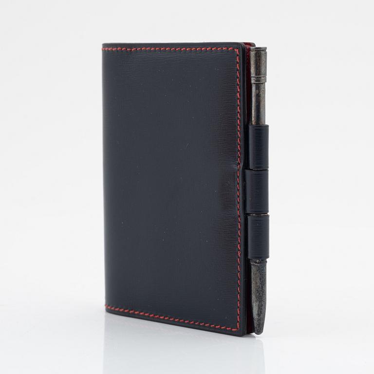 Hermès, a black leather notebook case & sterling silver pen.