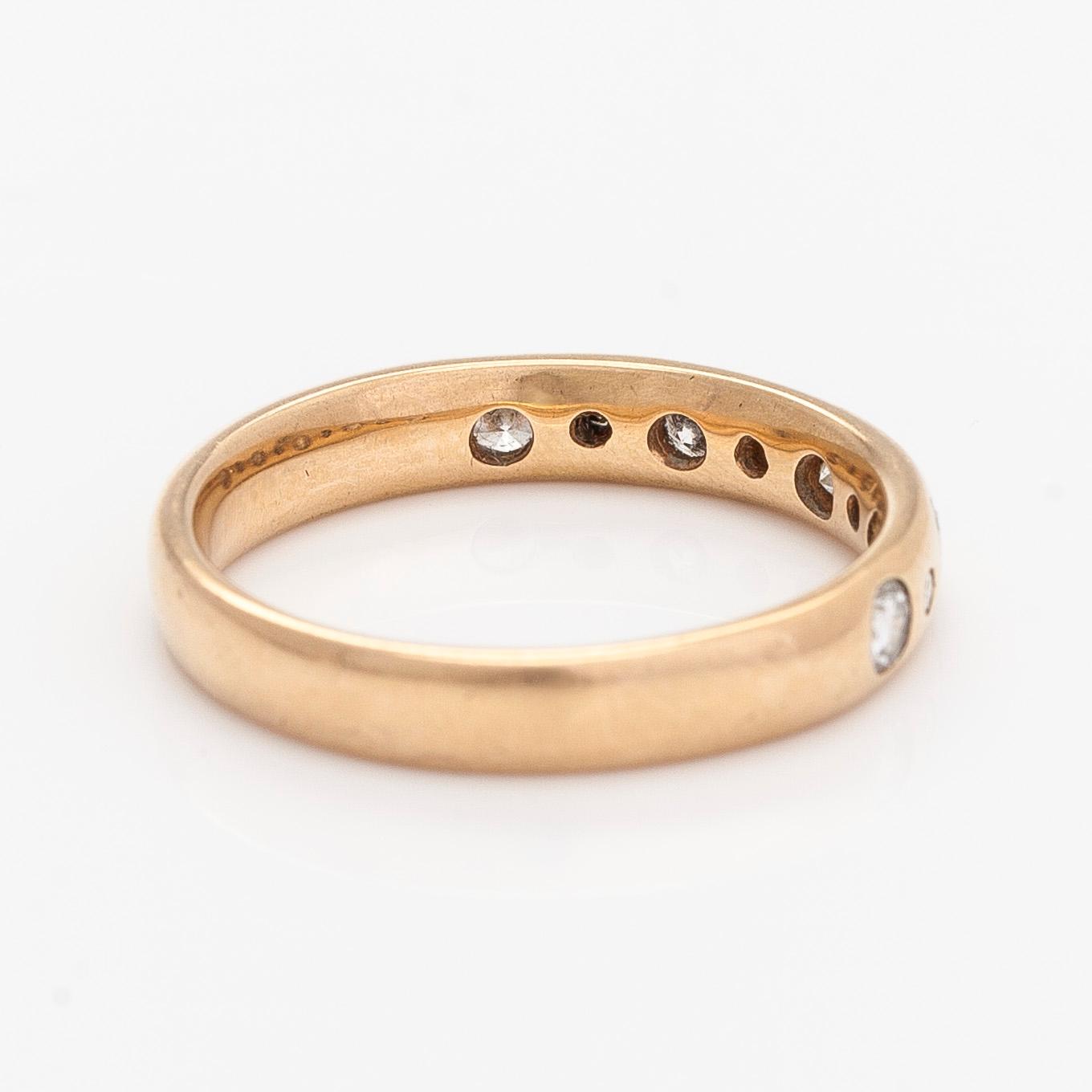 A 14K gold half eternity ring, set with brilliant-cut diamonds, total approximately 0.26 ct. Finnish import marks  1997.