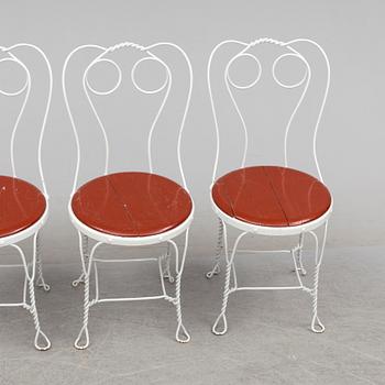 A garden table and four chairs, first half 20th century.