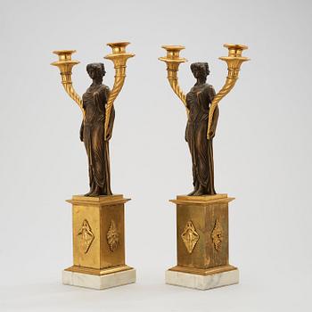 A pair of late Gustavian circa 1800 gilt and patinated bronze two-light candelabra.