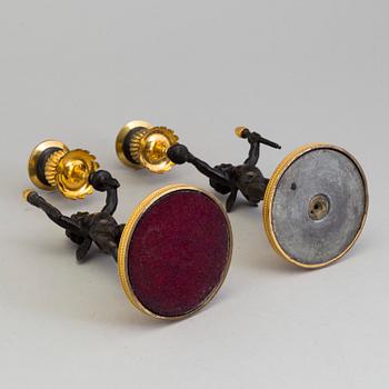 A pair of late 19th century, gilded bronze, Empire style, candle sticks.