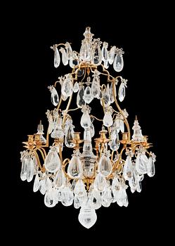 A late Baroque-style circa 1900 rock crystal twelve-light chandelier.