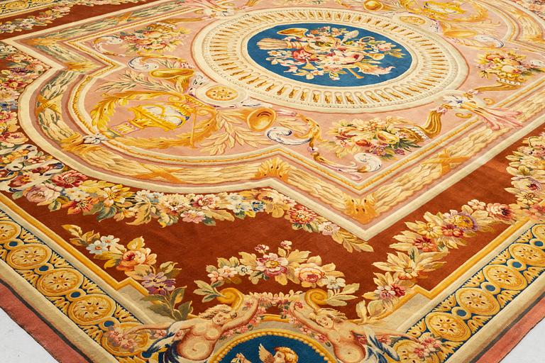 A carpet in savonnerie technique, ca 560 x 429 cm, Louis XVI style.