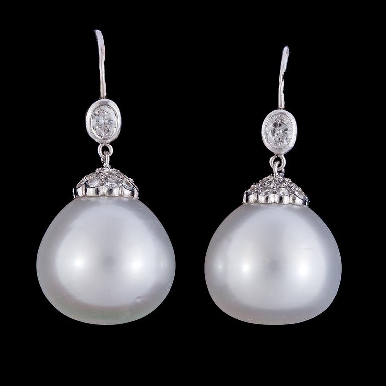A pair of cultured South sea pearl, 15,3 mm, and diamond earrings, tot. app. 0.75 cts.