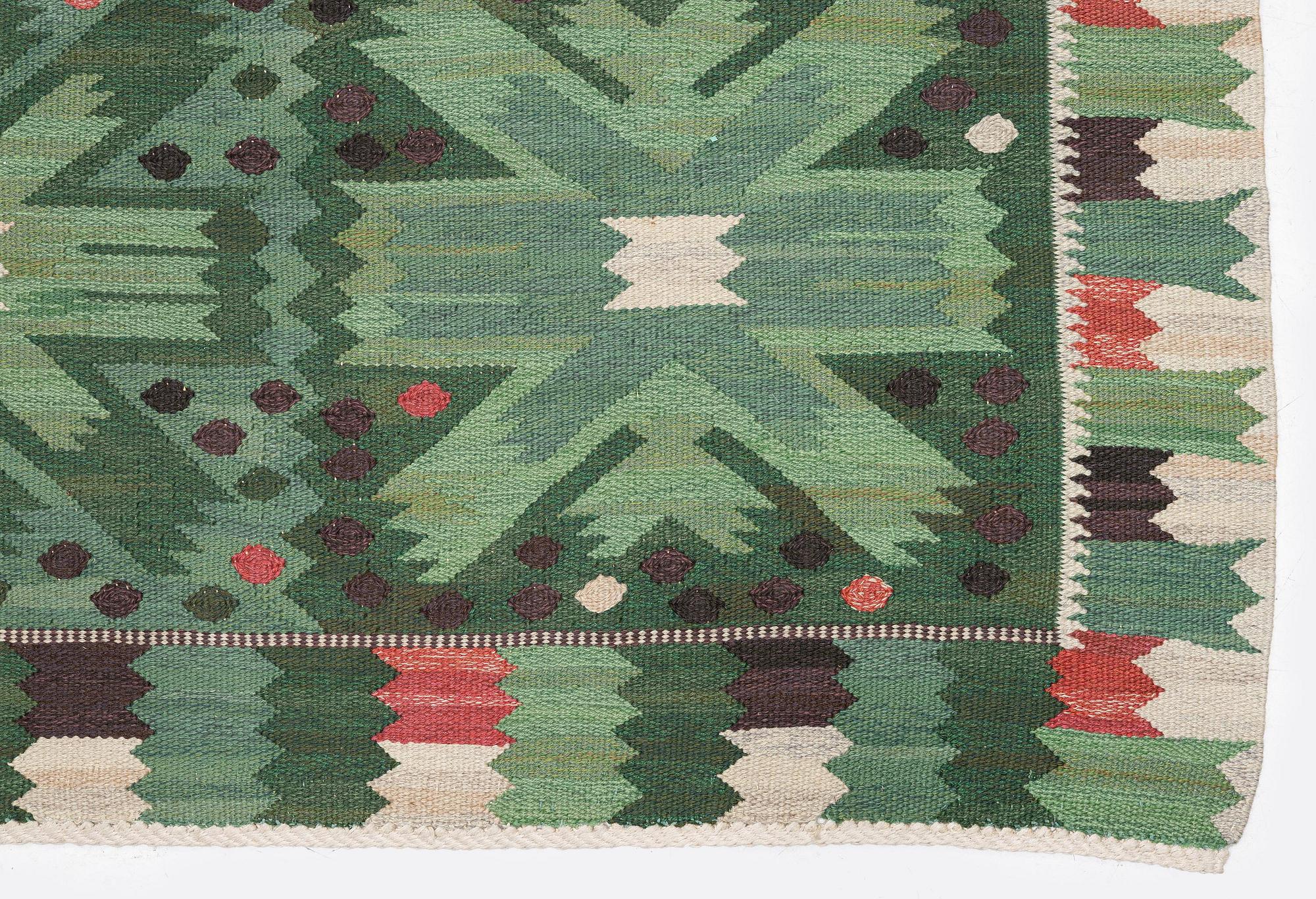 Barbro Nilsson, a carpet 'Nejlikan grön', flat weave, c. 390 x 278 cm, signed AB MMF BN.