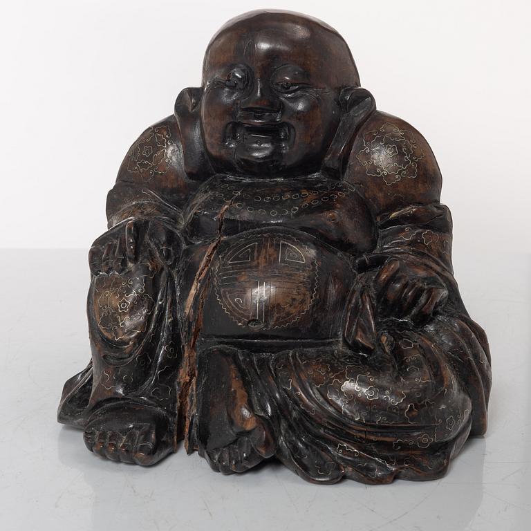 A Chinese wooden figure of Budai with silver inlays, Qing dynasty (1644-1912).