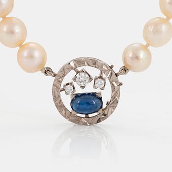 1065. A Rey Urban cultured pearl necklace with an 18K white gold clasp set with a cabochon-cut sapphire.