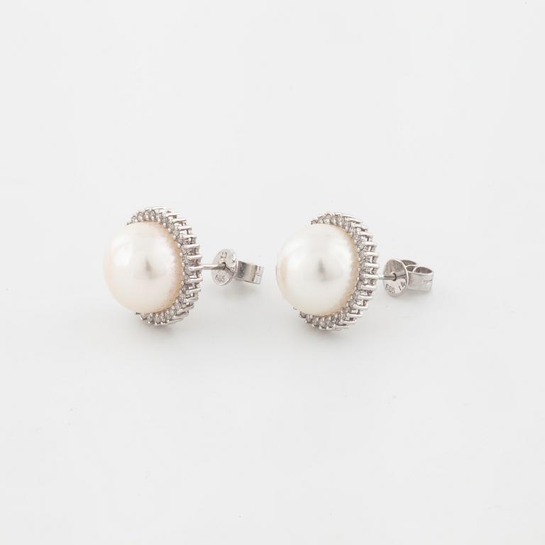 A pair of mabe pearl and brilliant cut diamond earrings.