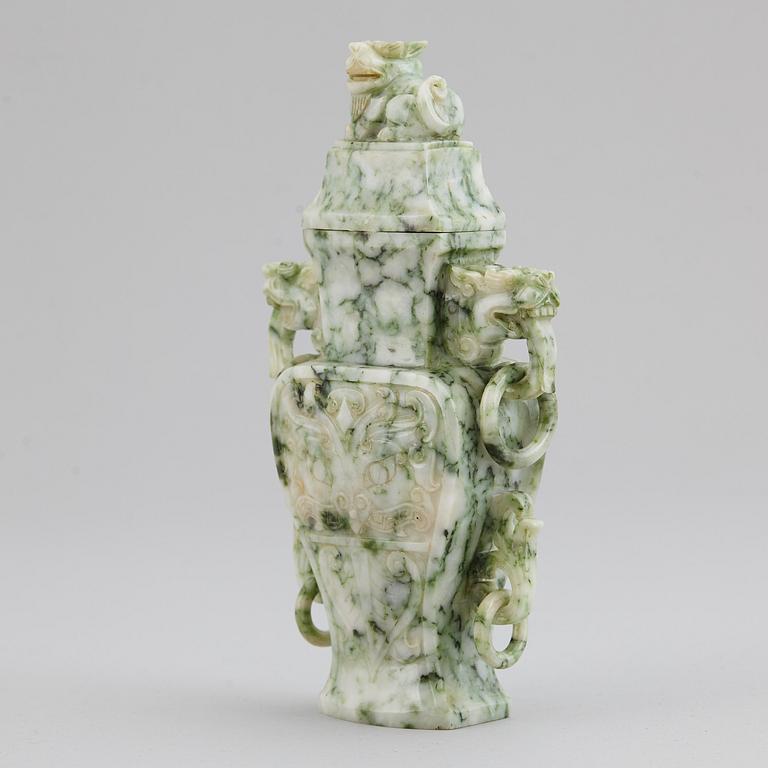 A carved green stone vase with cover, China, 20th Century.