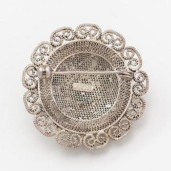 A silver bracelet and ring with turquoises. China.