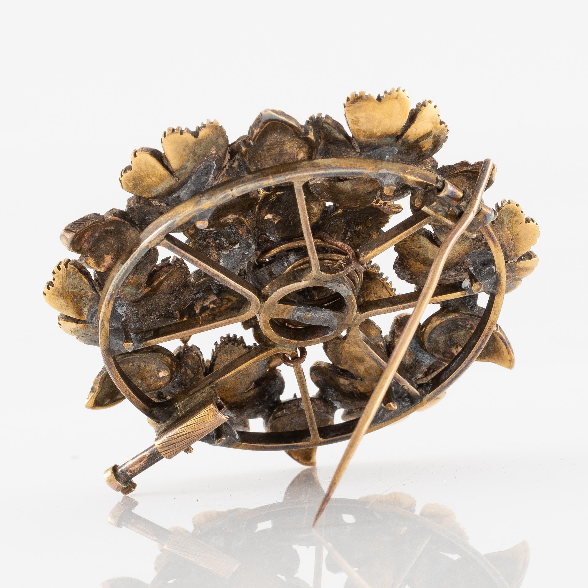 A brooch flower with rose-cut diamonds.