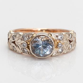 A 14K gold ring with diamonds ca. 0.18 ct in total, and a topaz.