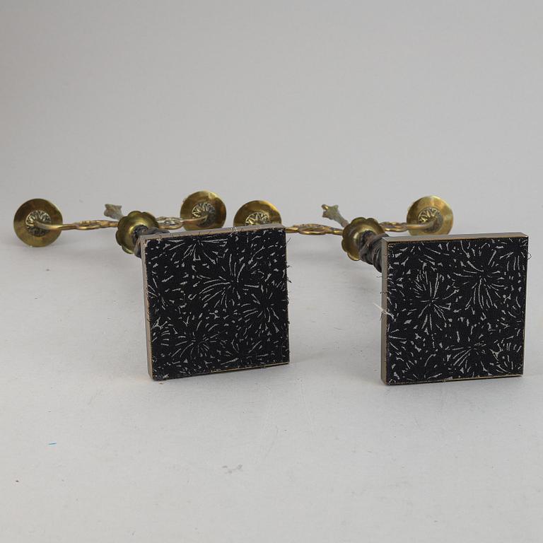 A pair of brass Empire style candle holders, 20th century.