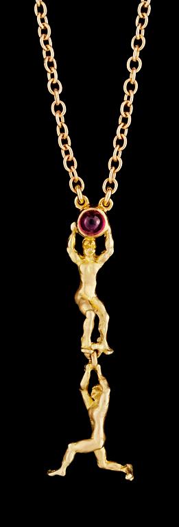 A gold and ruby pendant.