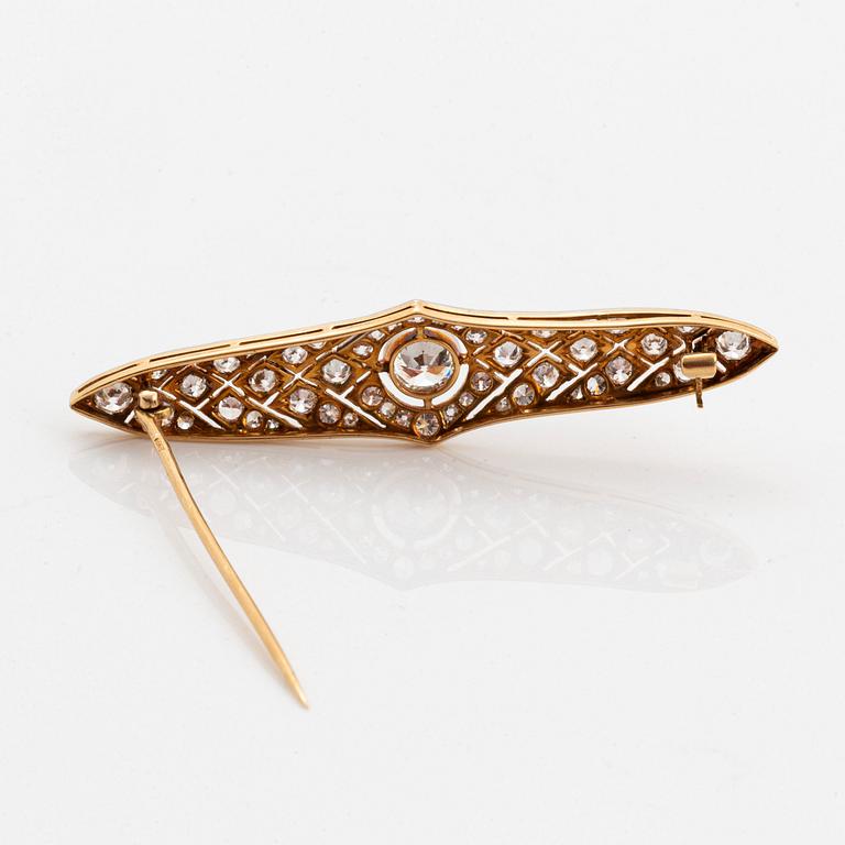 A platinum and 14K gold brooch set with an old-cut diamond weight ca 1.05 cts quality ca H si.