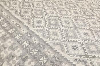 A kilim carpet, c 590 x 407 cm.