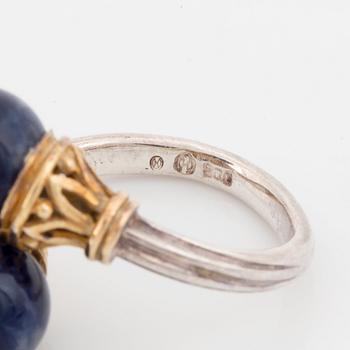 An Ilias Lalaounis demi parure comprising a necklace, a bracelet and a ring in silver and 18K gold set with sodalite.